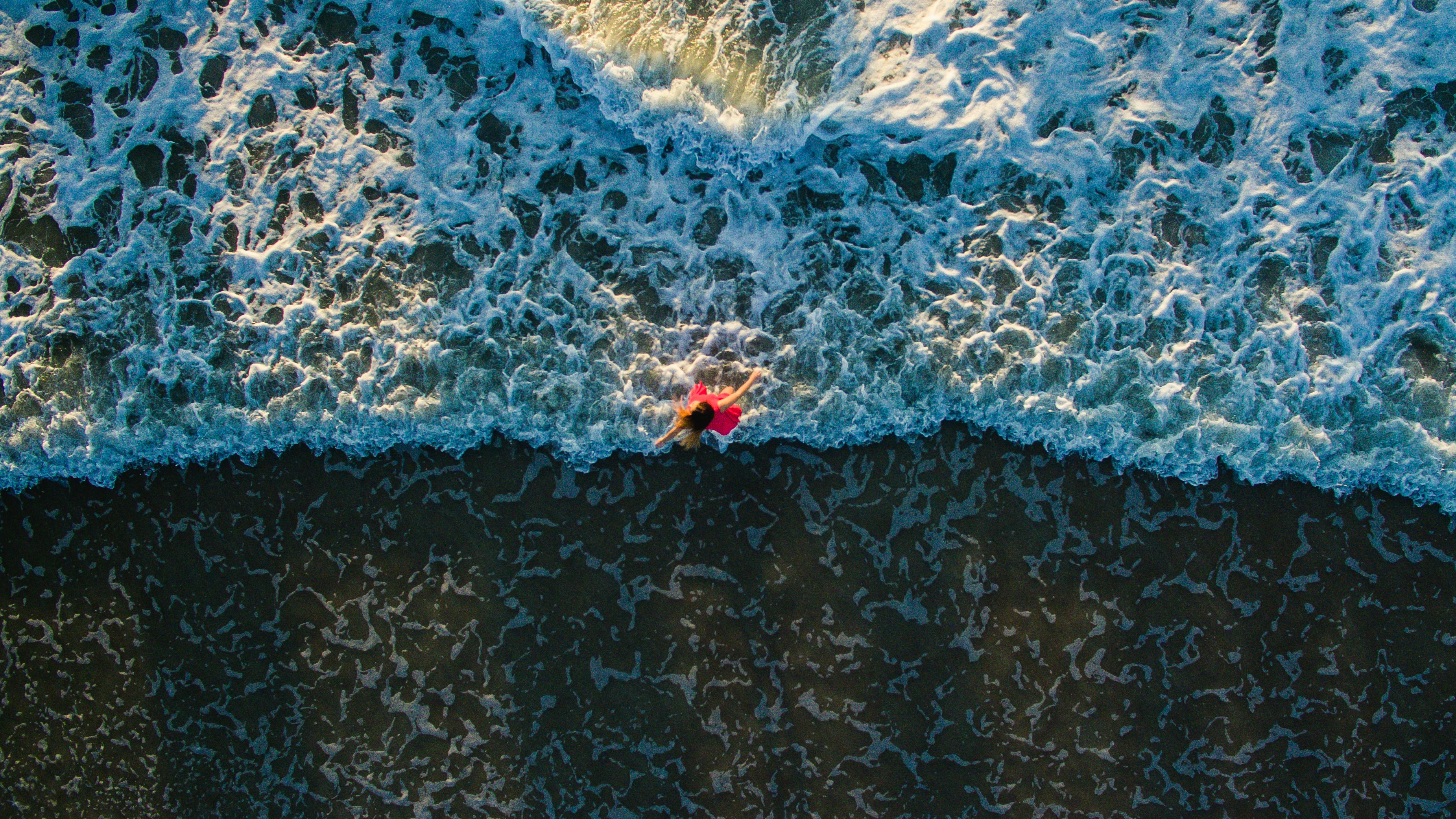 aerial photo of woman standing on shore